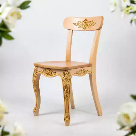 Teak armchair with detailed elephant motif hand carved into high backrest showing deep relief carving technique used by TimberArt artisans