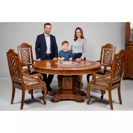 Eight seater rosewood dining table with Mehta family crest carved in center circle scaled from grandmother silver jewelry design completed September two thousand twenty four