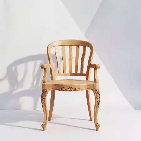 Traditional Indian dining chair made from rosewood with intricate peacock tail carved backrest and mortise tenon joinery throughout